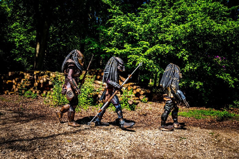 Three actors dressed as The Predator march through woodland in the grounds near The Yorkshire Event Centre.