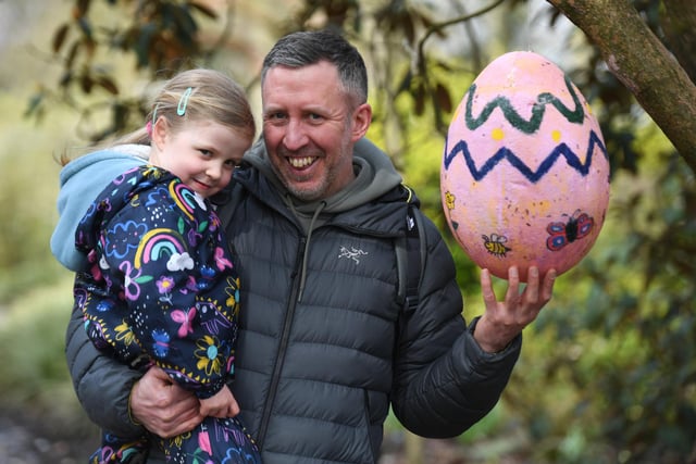 Four-year-old Erin Catley and her dad Paul with one of the eggs in the tree