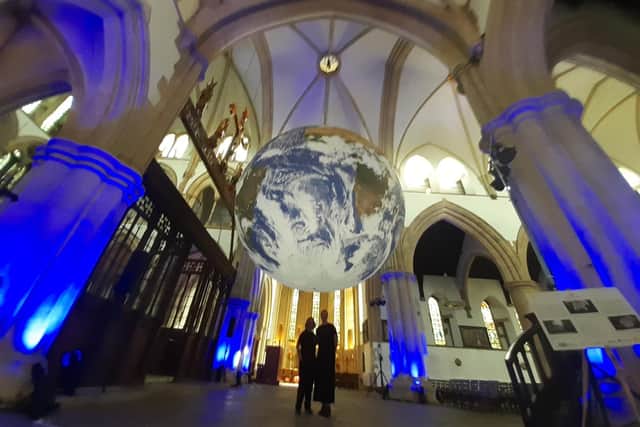 Spectacular - Harrogate International Festivals' Lisa McKiddie, Digital and Communications Coordinator, and Charlotte Wilkinson, Head of Operations, underneath artist Luke Jerram's Gaia in St Wilfrid's Church. (Picture Graham Chalmers)