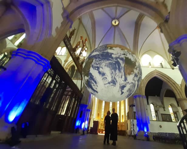 Spectacular - Harrogate International Festivals' Lisa McKiddie, Digital and Communications Coordinator, and Charlotte Wilkinson, Head of Operations, underneath artist Luke Jerram's Gaia in St Wilfrid's Church. (Picture Graham Chalmers)