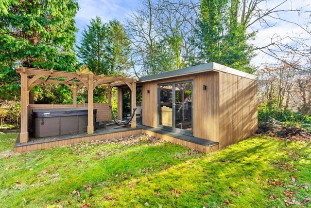 A garden home office, and a hot tub area with pergola are among the facilities with this property.