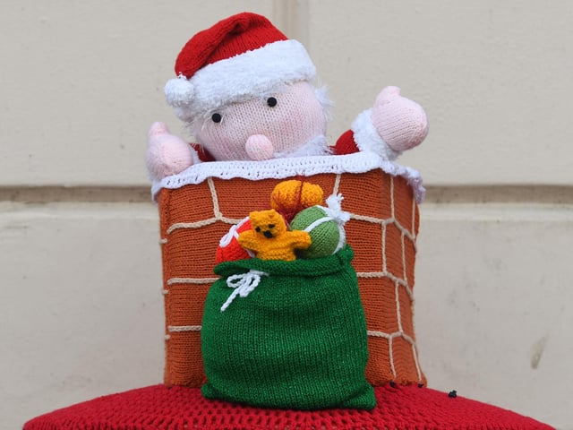 Knitted decorations on a post box in Ripon