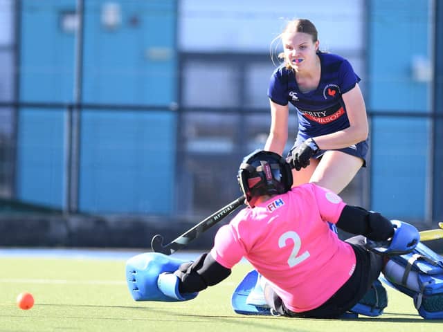 Harrogate Hockey Club Ladies 1s' Brooke Allen beats the Huddersfield Dragons goalkeeper during Saturday's Yorkshire & North East Division One encounter. Pictures: Gerard Binks