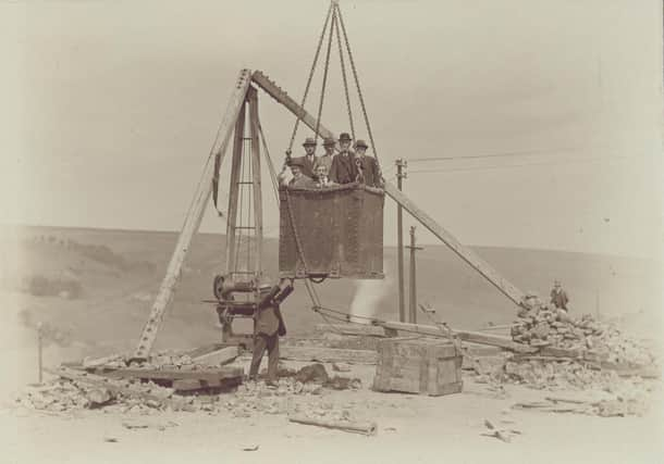 Angram Reservoir - VIP's having a ride in a large bucket lifted by a crane.