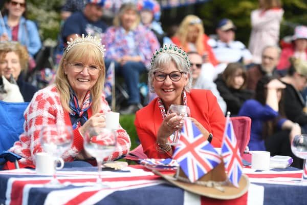 Crowds dressed in red white and blue enjoy the King's Coronation.
