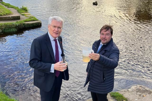 Harrogate and Knaresborough MP Andrew Jones and Frank Maguire, owner of the 550-home Knaresborough Lido, looking at a sample of the river water at the Nidd.