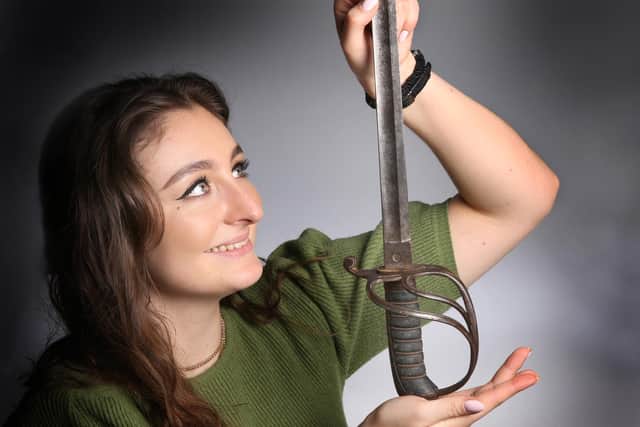 Sharp end of history - Julia Matyear from Ripon-based Elstob Auctioneers with the sword that saw action in the Charge of the Light Brigade. (Picture contributed)