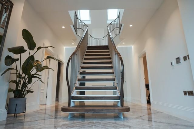 A front view of the staircase that rises from the hall to the first floor gallery landing.