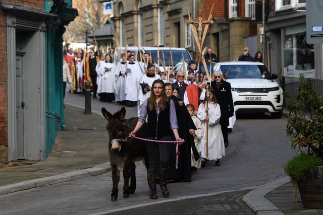 Palm Sunday procession from Ripon Market Square to the Cathedral. Lily-May Horn leads Lily the donkey.