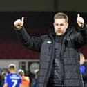 Harrogate Town manager Simon Weaver celebrates in front of the Sulphurites' travelling fans after his team secured their Football League status at Newport County. Picture: Graham Hunt/ProSportsImages