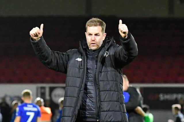 Harrogate Town manager Simon Weaver celebrates in front of the Sulphurites' travelling fans after his team secured their Football League status at Newport County. Picture: Graham Hunt/ProSportsImages