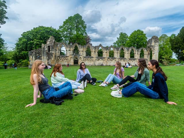 Visitors to York enjoying the warm weather while relaxing in York Museum Gardens.