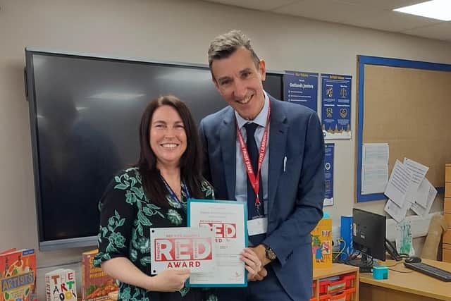Harrogate school wins award - Miss Kate Woodcock, Deputy Headteacher and Inclusion Manager at Rossett Acre Primary School is presented with the RED Award by CEO of Red Kite Learning Trust, Mr Richard Sheriff, OBE. (Picture contributed)