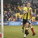 Tom Cursons celebrates after firing Harrogate Town into a 3-1 lead against Fleetwood, a result which guaranteed their Football League status for another season. Pictures: Paul Thompson/ProSportsImages