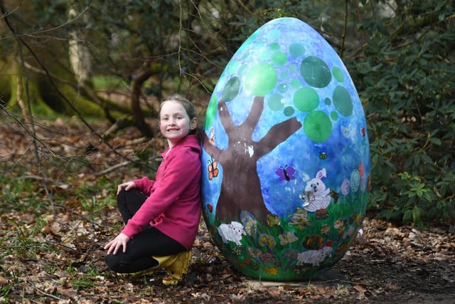 Six-year-old Mary Walker poses with one of the giant eggs