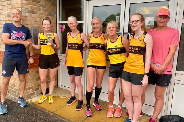 Martin Brock, chairman of the Knaresborough Lions organising committee, who is a keen runner himself, presents the Nidd Valley Road Runners Ladies team from Harrogate with a trophy for their superb efforts in this year's Knaresborough Bed Race.