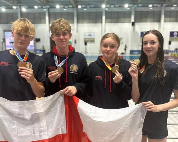 Proud member of the England team - Harrogate Grammar School's Gabe Shepherd, second from left, is now a world champion in swimming. Picture contributed)