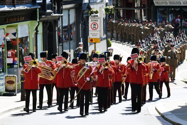Musicians play as the band leads the parade