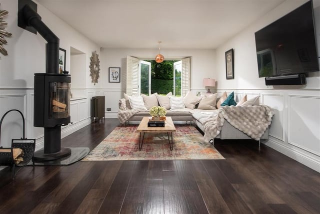 Relaxed space with a modern stove and doors opening to outside.