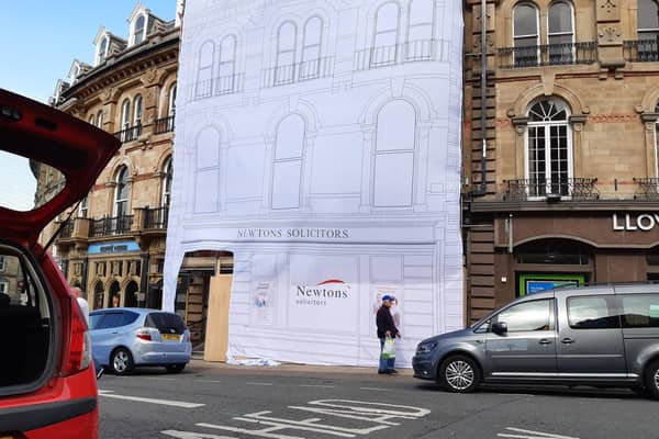 The empty three-storey building at 5 Cambridge Crescent in Harrogate is currently shrouded in a giant white sheet with Newton Solicitors branding displayed. (Picture Graham Chalmers)