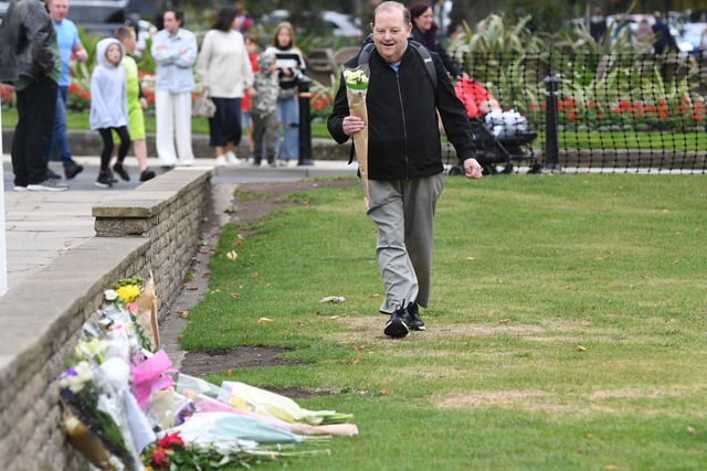 A member of the public lays flowers at the Cenotaph in Harrogate.