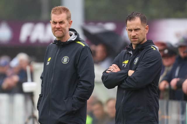 Harrogate Town boss Simon Weaver, left, is hoping to keep hold of Luke Armstrong amidst growing interest in his star striker.