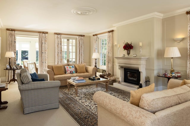 A traditional style lounge with a feature fireplace.