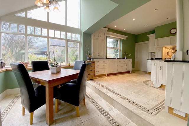 The bright and spacious kitchen with diner has views of the well-tended gardens.