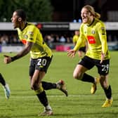 Harrogate Town defender Kayne Ramsay, centre, celebrates after his stoppage-time strike is deflected over the goal-line by Grimsby Town stopper Max Crocombe. Pictures: Ben Roberts/ProSportsImages