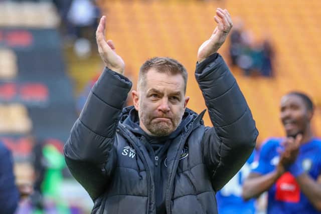 Harrogate Town manager Simon Weaver applauds the travelling support following Saturday's FA Cup win over Bradford City.