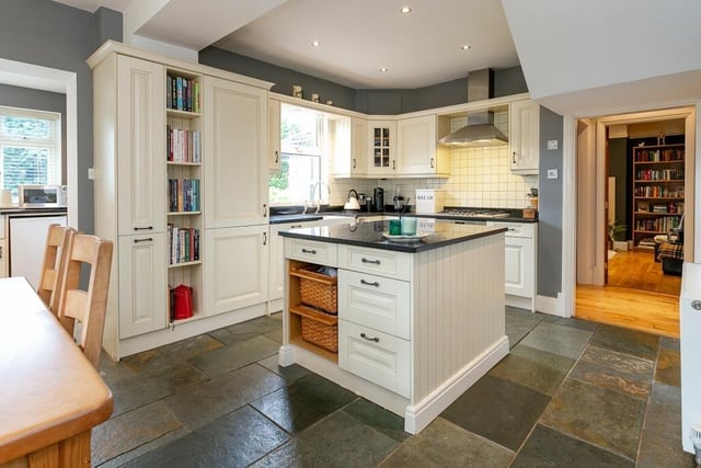 A modern fitted kitchen with central island.