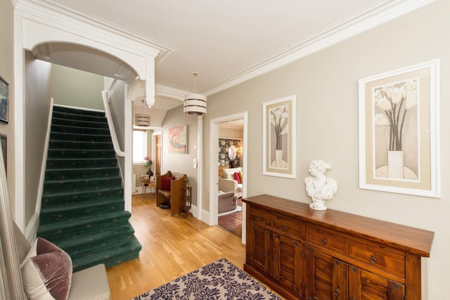 A spacious hallway with the staircase leading up.