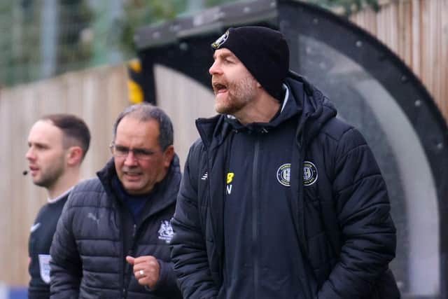 Harrogate Town manager Simon Weaver watches on.