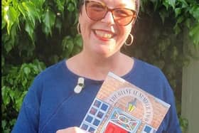 Illustrator Helen Morgan with a copy of 'The Giant at Number Two'