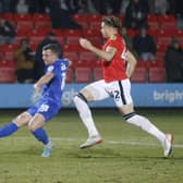 Jack Muldoon slots the ball home to hand Harrogate Town a 50th-minute lead against Salford City on Tuesday evening. Pictures: Paul Thompson/ProSportsImages