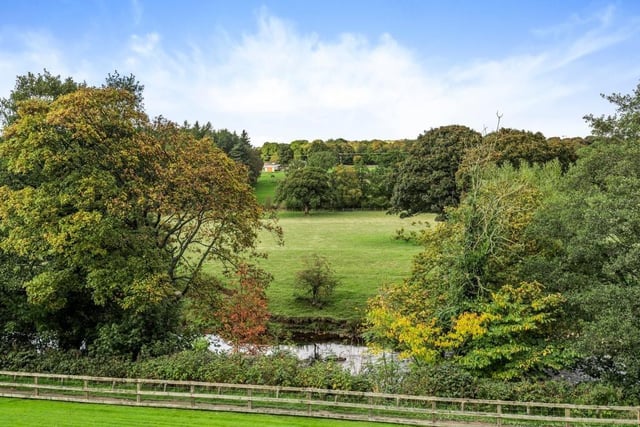 Countryside stretches behind the River Nidd