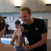 British Olympic swimming hero Luke Greenbank shows off a medal at a previous swimming clinic at Harrogate’s Ashville College.