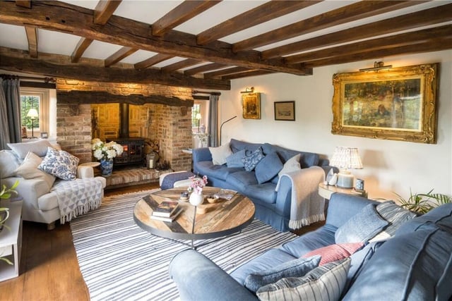A cosy-yet-spacious beamed reception room with a large inglenook fireplace.