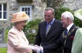 Visiting the set of Emmerdale in 2002. The Queen and Duke of Edinburgh's visit to Harewood House and the Emmerdale set. The Queen meets Emmerdale actor Chris Chittell, right, and Emmerdale Line Producer Tim Fee.