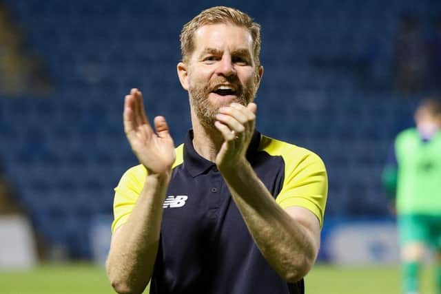 Simon Weaver applauds Harrogate Town's travelling fans after the full-time whistle.