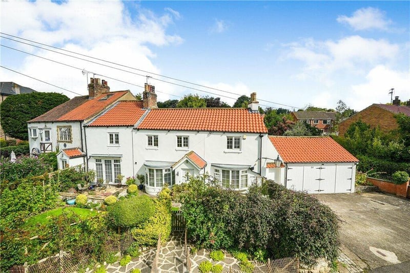 The attractive frontage of the cottage and gardens.