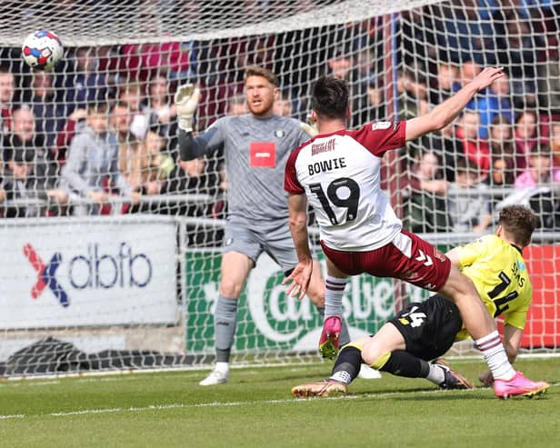 Kieron Bowie volleys Northampton Town's third goal past Harrogate Town stopper Mark Oxley during Saturday's League Two clash at Sixfields. Pictures: Pete Norton/Getty Images