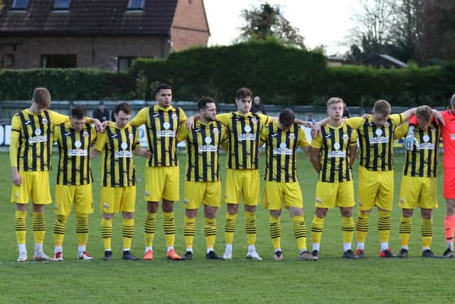 Knaresborough Town's players observe a two-minute silence before their Armistice Day clash with Tadcaster Albion.