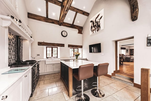 There is space for a family breakfast table. Appliances include an Aga range oven, separate electric oven and wine cooler, whilst leading off the kitchen is a fully tanked wine cellar.