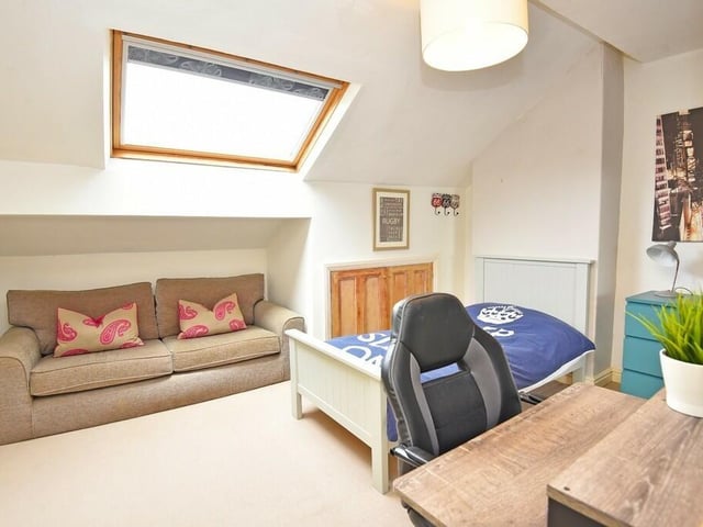 This second floor bedroom with skylight window has plenty of space for freestanding furniture.