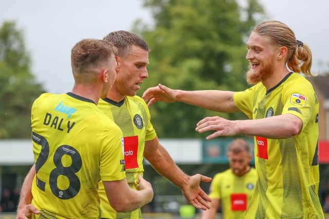 Jack Muldoon, centre, is congratulated by team-mates Matty Daly and Luke Armstrong after finding the net against Swindon Town during Harrogate Town's opening-day triumph over Swindon.