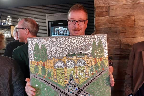 Douglas Thompson with FEVA mosaic gift to Bebra