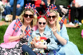 Pictured dressed in red, white and blue are Amy, Francesca and Alison Crabbe enjoying the King's Coronation.