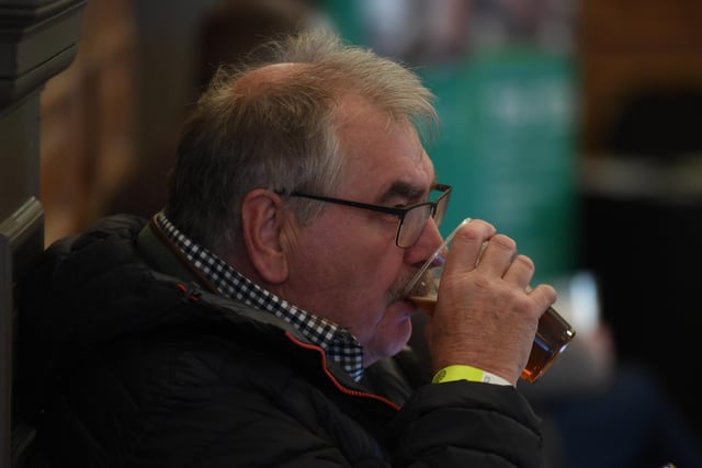 A customer and festival goer enjoys a pint.