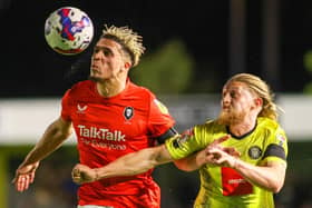 Harrogate Town striker Luke Armstrong, right, challenges Salford City's Theo Vassell during Tuesday night's League Two clash between the sides. Pictures: Matt Kirkham